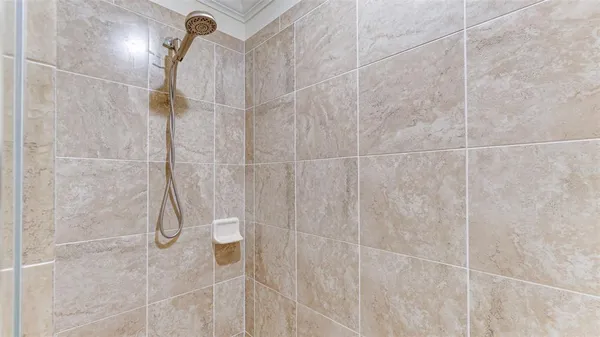 a bedroom with a bed and a flat tv screen on dresser