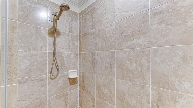 a bedroom with a bed and a flat tv screen on dresser