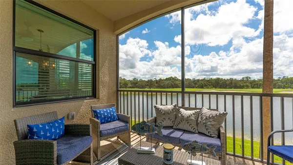 a view of a city from a balcony with furniture