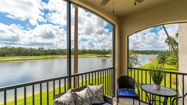 a view of a swimming pool with lake and trees in the background