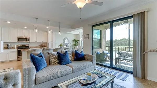 a view of living room kitchen with furniture and wooden floor