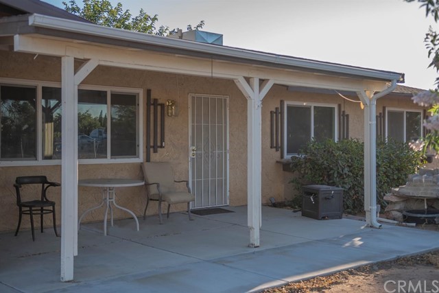 11740 Pasco Road Apple Valley, CA 92308 - Photo 1 of 1 a view of a house with backyard porch and sitting area