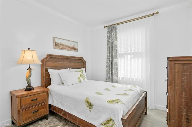 a bedroom with a bed and lamp