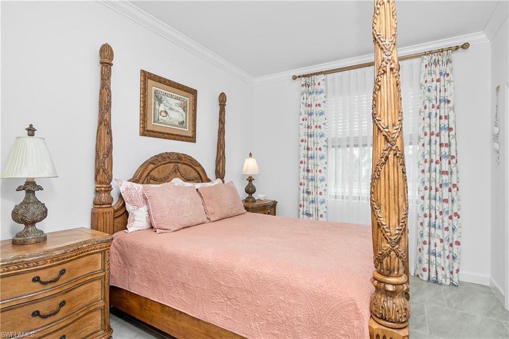 20072 Napa Loop Estero, FL 33928 - Photo 13 of 41 a bedroom with a bed and a chandelier