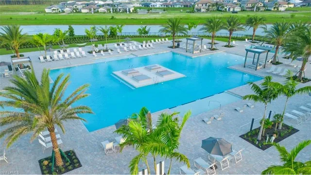 a swimming pool with outdoor seating and yard