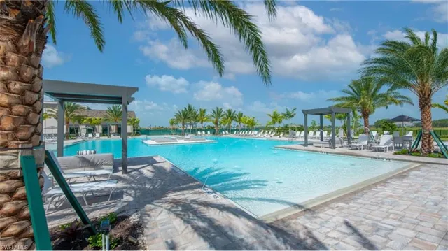 a swimming pool with outdoor seating and yard