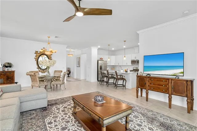 a living room with furniture a rug and a table