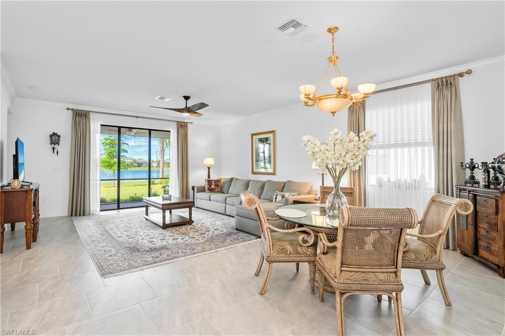 20072 Napa Loop Estero, FL 33928 - Photo 5 of 41 a dining room with wooden floor a chandelier a glass table and chairs