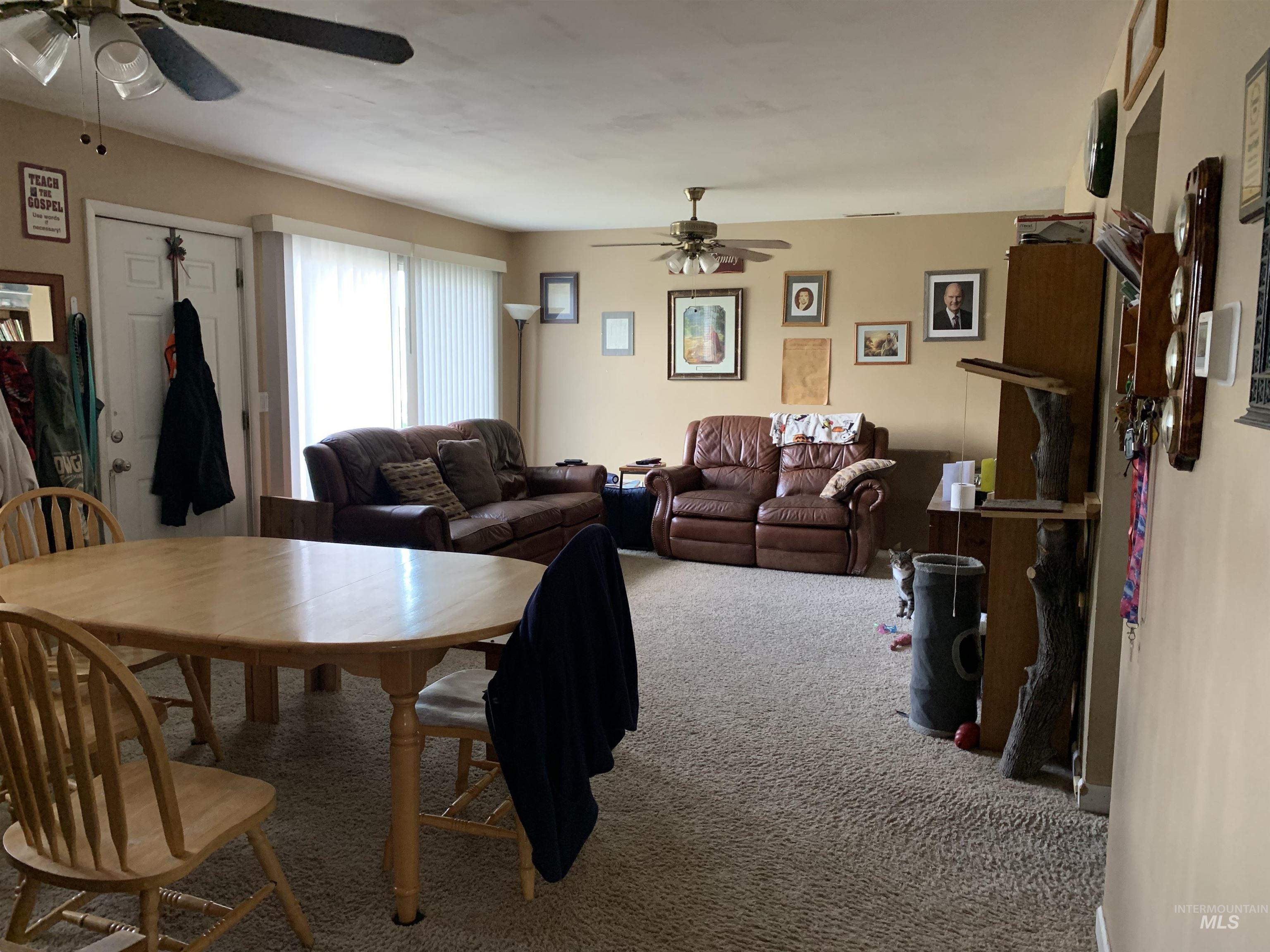 917 15th Drive Rupert, ID 83350 - Photo 2 of 4 Spacious living area featuring neutral-toned walls and ceiling fans