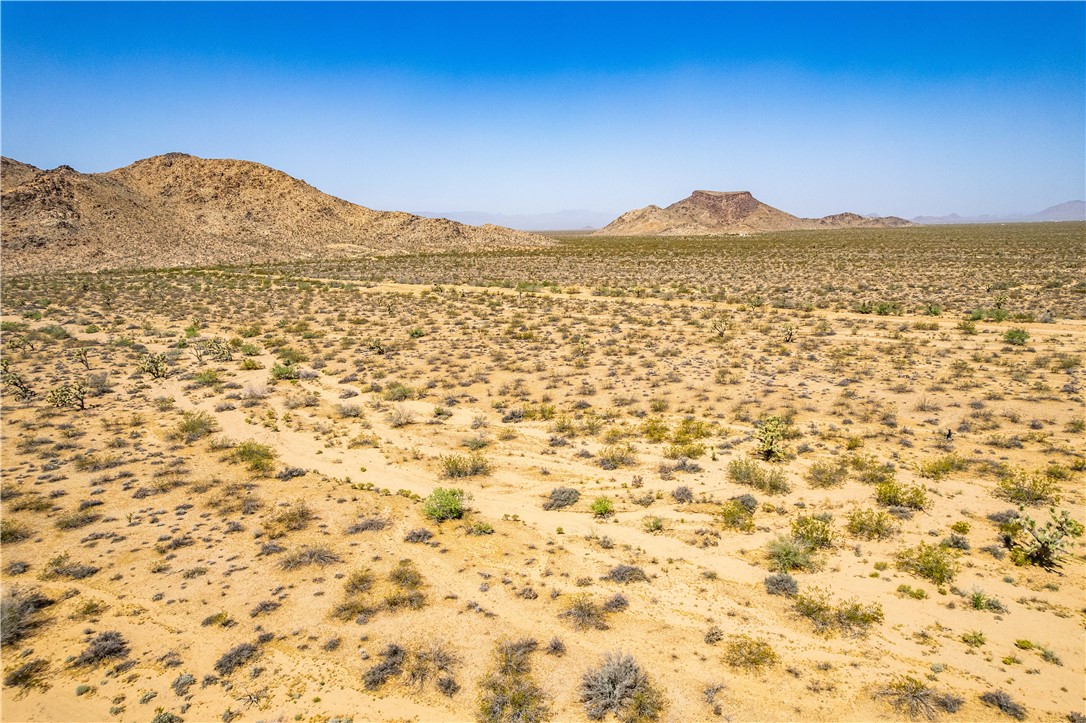 0 East Arroyo Road Yucca, AZ 86438 - Photo 16 of 25 Expansive property with a desert landscape featuring scattered low-lying vegetation and distant mountains
