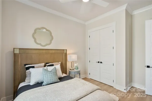 a bedroom with a bed and a painting on the wall