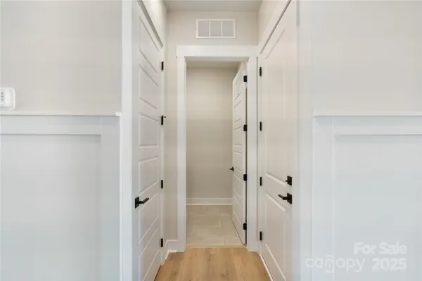 a view of a hallway with closet and wooden floor