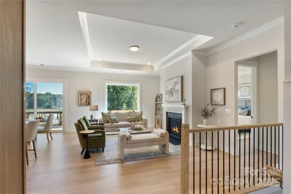 a living room with furniture large window and a fireplace
