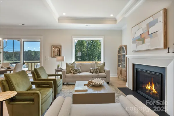 a living room with furniture large window and a fireplace