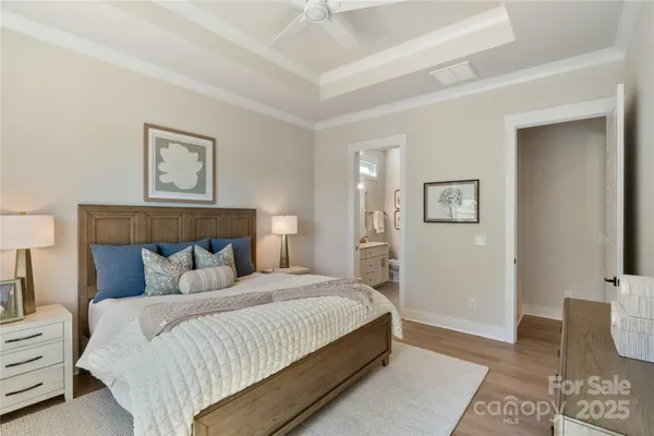 a bedroom with a bed and painting on the wall