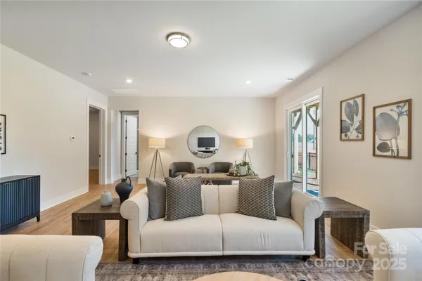 a living room with furniture and a wooden floor