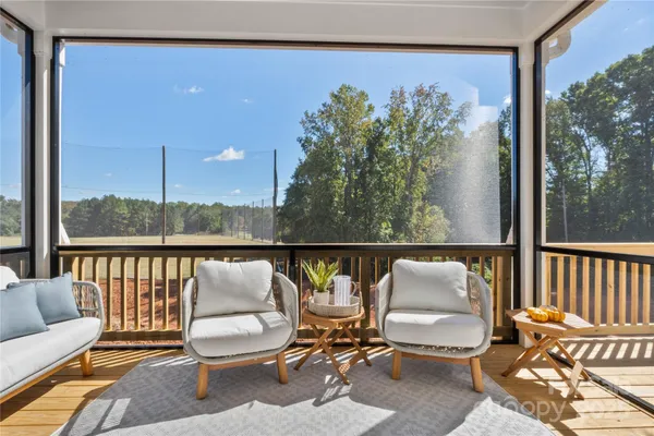 a balcony with table and chairs