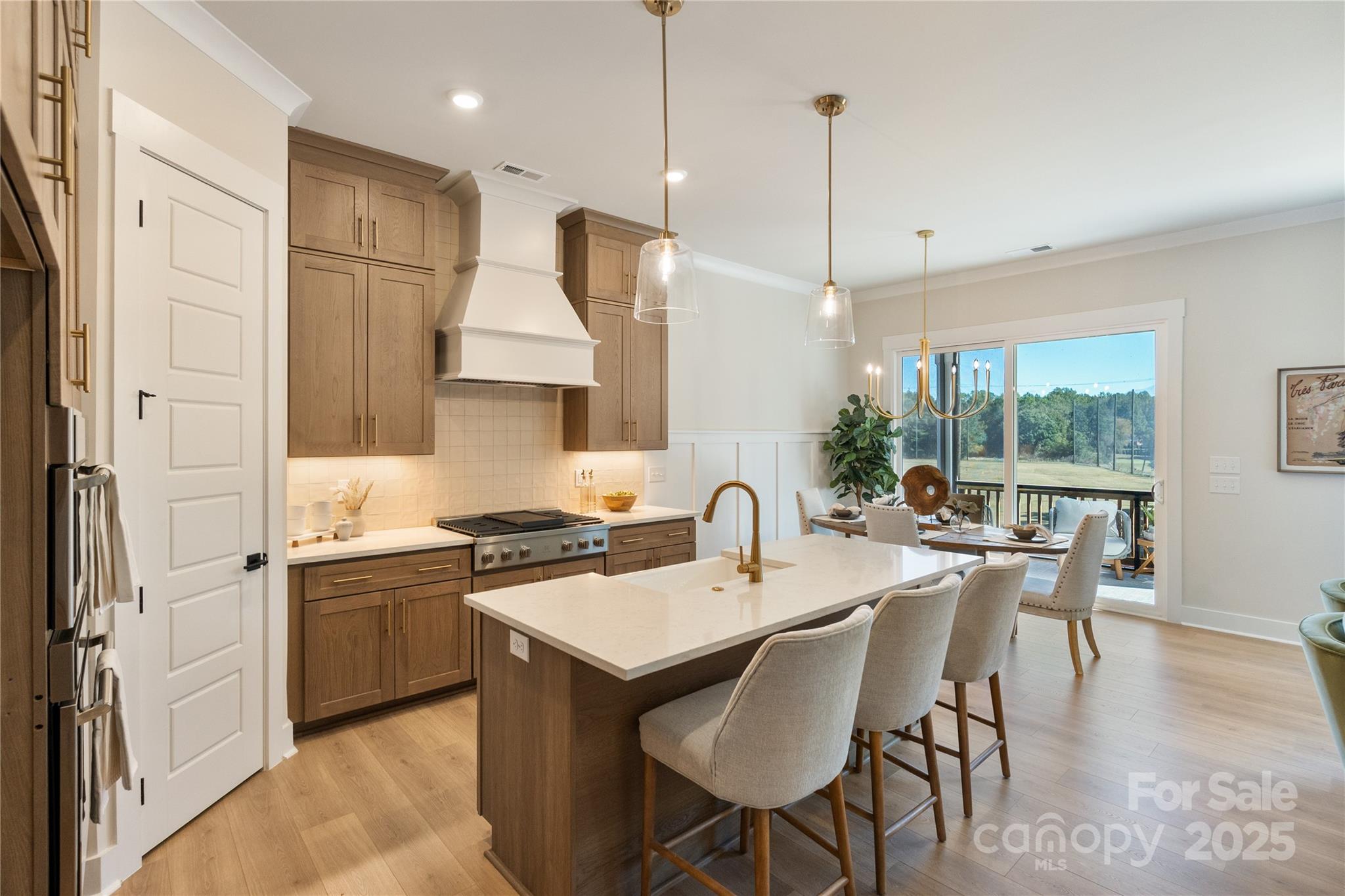 2085 Bonds Lane, Unit 26 Fort Mill, SC 29715 - Photo 4 of 41 a kitchen with stainless steel appliances granite countertop a stove a sink a refrigerator a dining table and chairs with wooden floor