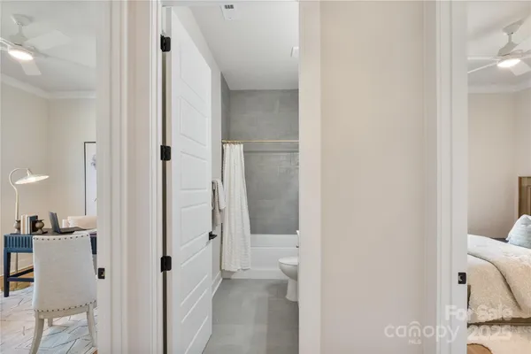 a view of a hallway with closet and bathroom