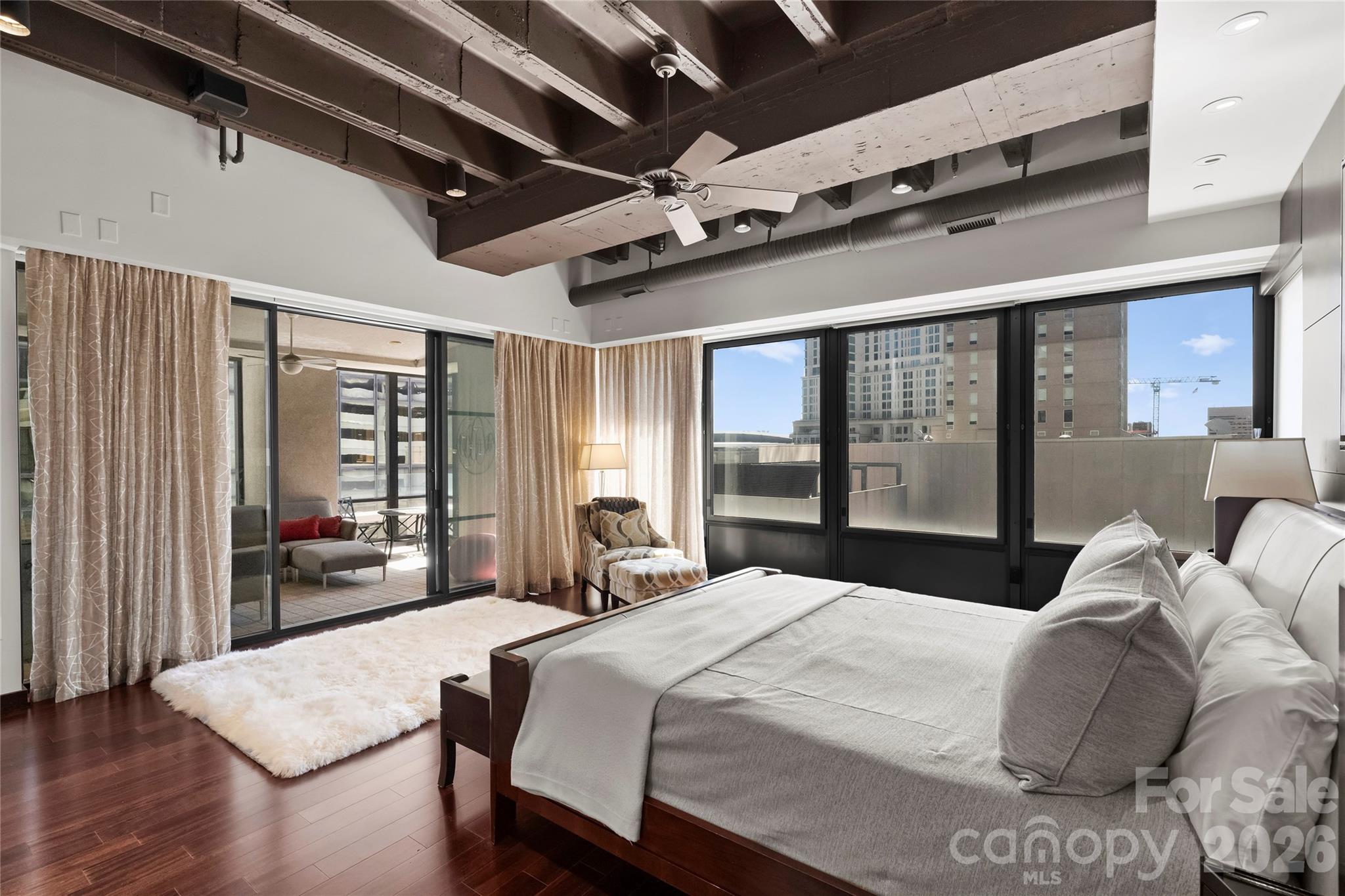 139 South Tryon Street, Unit 6 Charlotte, NC 28202 - Photo 29 of 47 a bedroom with a large bed and a large window