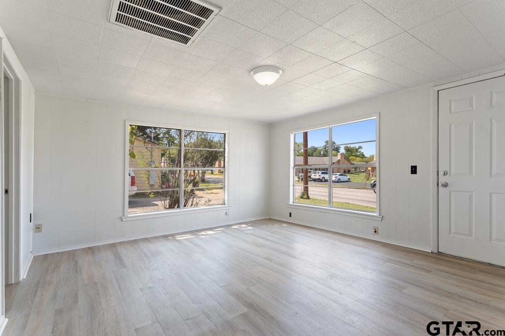 210 Cooper Street Lindale, TX 75771 - Photo 7 of 23 an empty room with wooden floor and windows