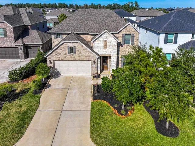 a aerial view of a house with a yard and potted plants