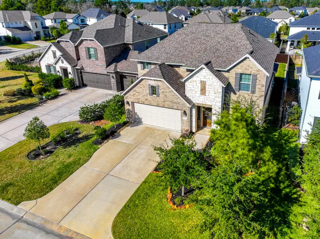 an aerial view of residential houses with outdoor space and street view