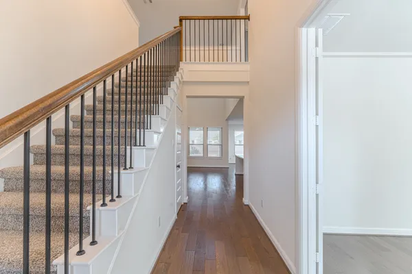 a view of kitchen with kitchen island a sink wooden floor and a living room view