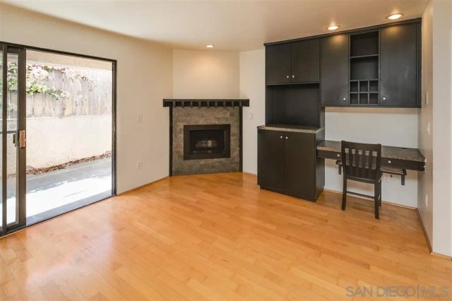 a view of livingroom with kitchen and fireplace