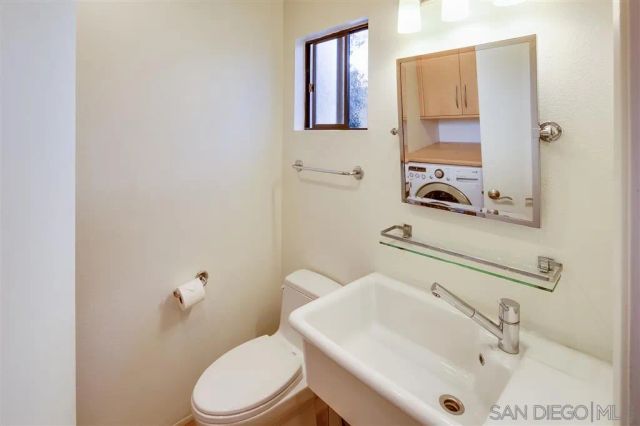a bathroom with a sink toilet and mirror