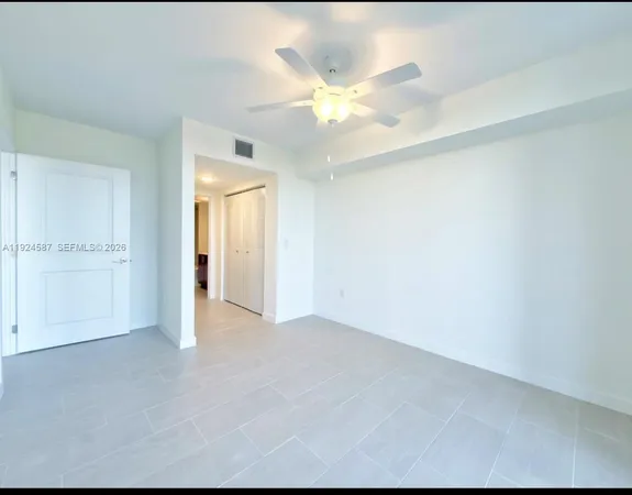 a view of an empty room with a ceiling fan