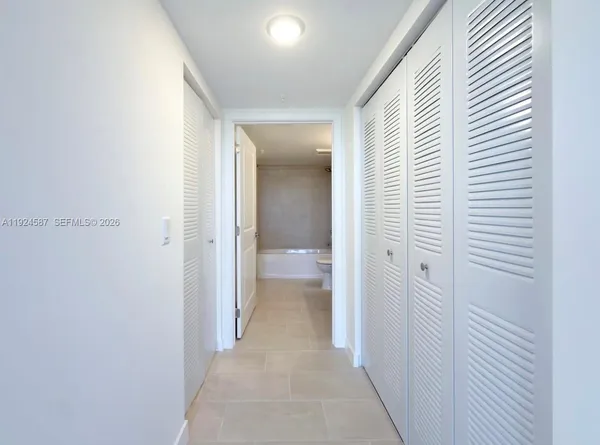 a view of a hallway with a wooden floor