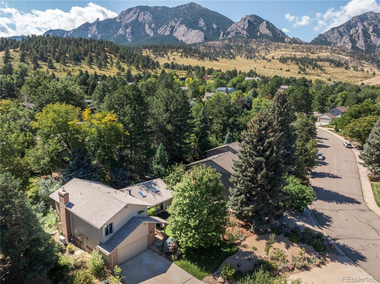 2464 Powderhorn Lane Boulder, CO 80305 - Photo 1 of 40 an aerial view of a house with a yard and mountain