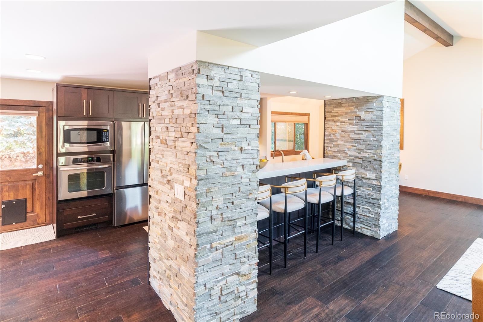 2464 Powderhorn Lane Boulder, CO 80305 - Photo 15 of 40 a view of a workspace with furniture and wooden floor
