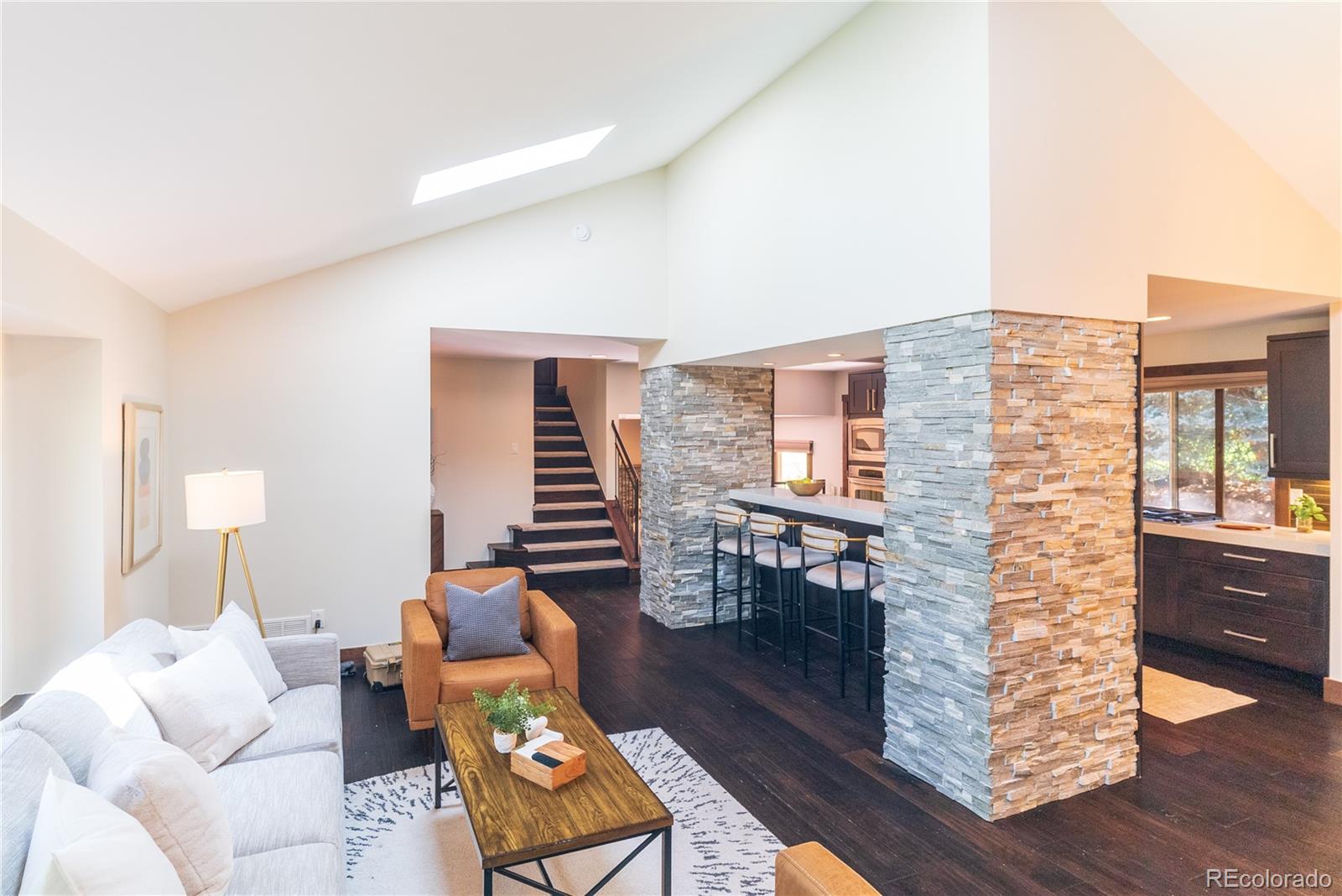 2464 Powderhorn Lane Boulder, CO 80305 - Photo 19 of 40 a living room with furniture a wooden floor and next to a window
