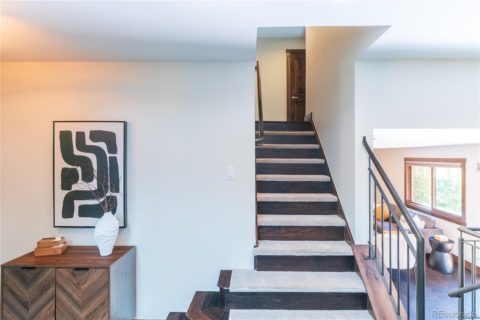 2464 Powderhorn Lane Boulder, CO 80305 - Photo 25 of 40 a view of staircase with wooden floor and windows