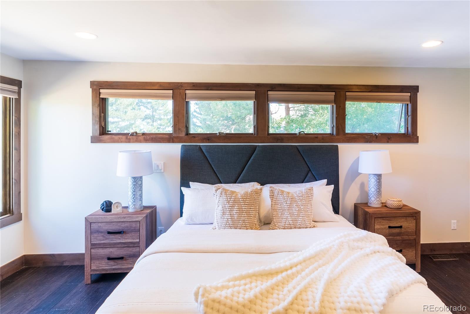 2464 Powderhorn Lane Boulder, CO 80305 - Photo 27 of 40 a bedroom with a bed and wooden floor