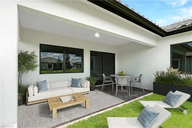 a living room with furniture a rug and a potted plant