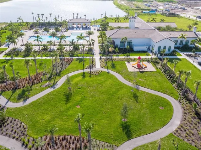 a large white kitchen with kitchen island a large island in the center