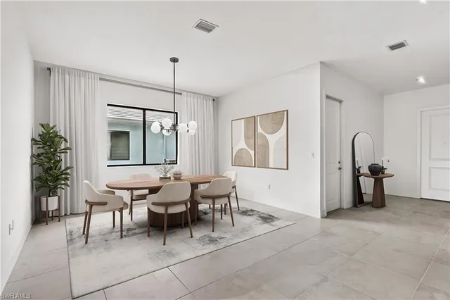 a dining room with furniture and a chandelier