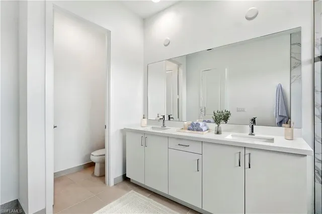 a bathroom with a double vanity sink and mirror