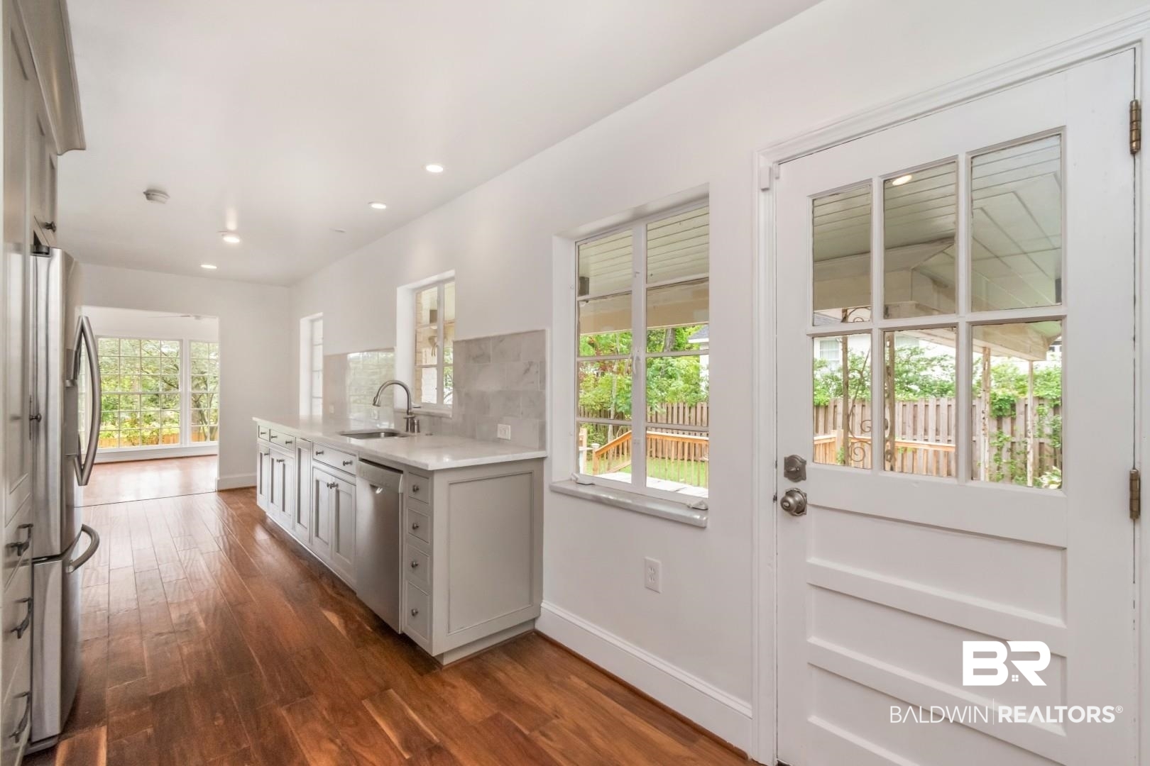 4 Turnout Lane Mobile, AL 36608 - Photo 9 of 53 Kitchen featuring dark wood-type flooring, stainless steel appliances, light stone counters, a peninsula, and recessed lighting