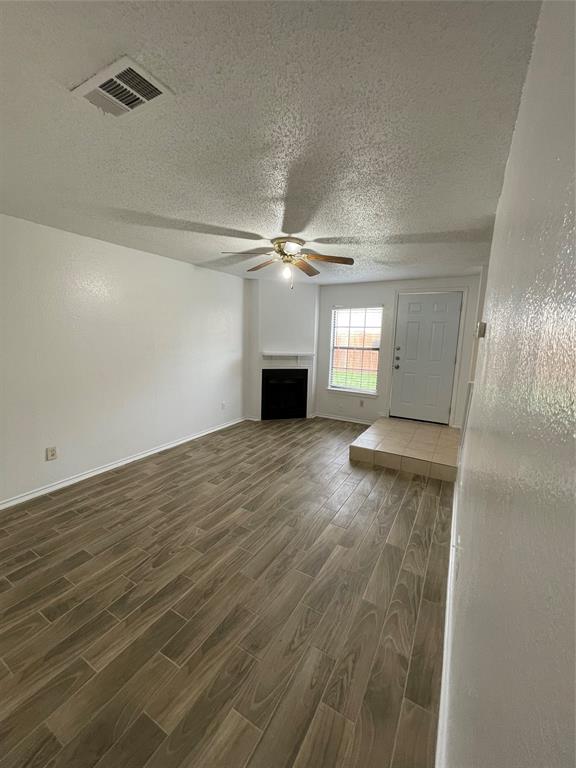 632 South Rogers Road Irving, TX 75060 - Photo 3 of 8 wooden floor in an empty room with a window