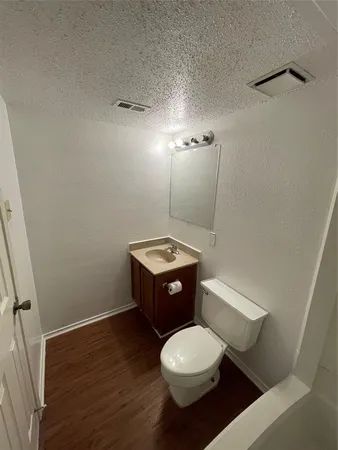 a bathroom with a toilet a sink and mirror