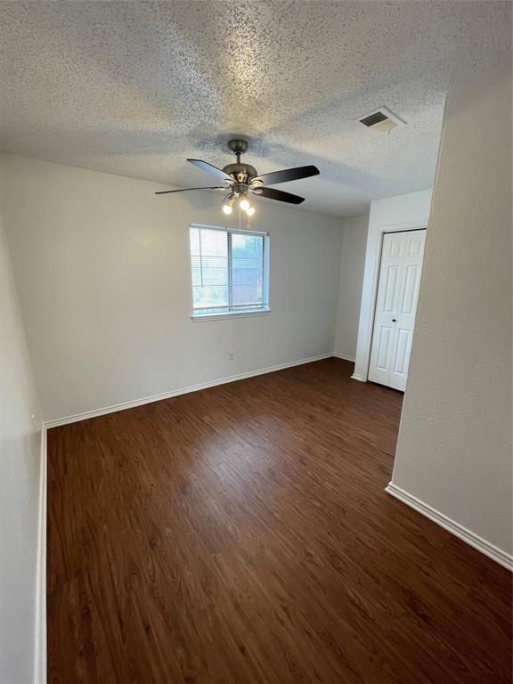 632 South Rogers Road Irving, TX 75060 - Photo 7 of 8 an empty room with wooden floor chandelier fan and windows