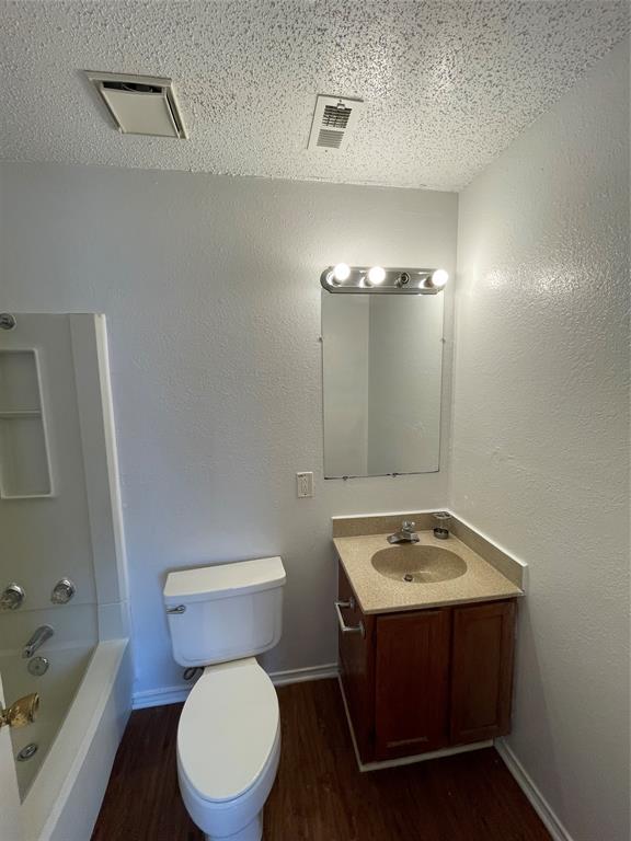 632 South Rogers Road Irving, TX 75060 - Photo 8 of 8 a bathroom with a sink vanity mirror and toilet