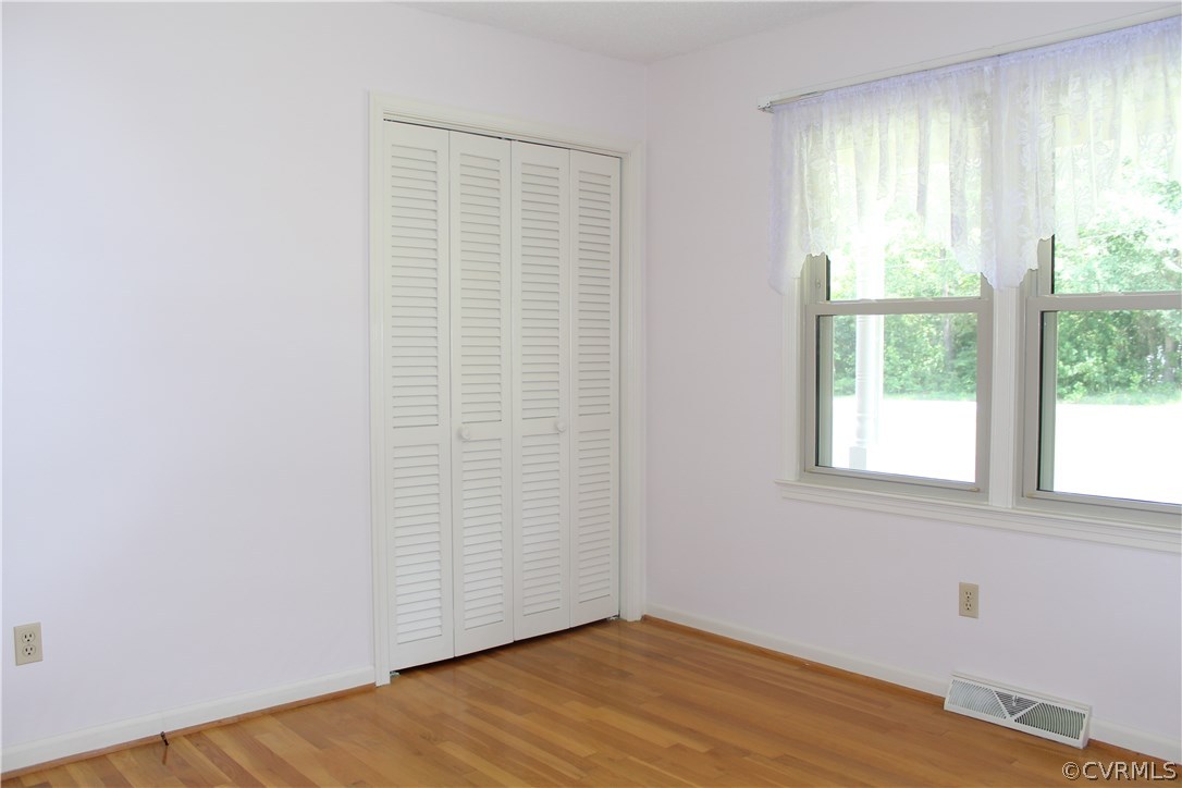 20600 Rowanty Road Carson, VA 23830 - Photo 16 of 25 an empty room with wooden floor and windows