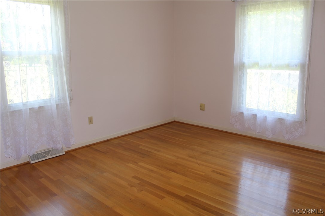 20600 Rowanty Road Carson, VA 23830 - Photo 18 of 25 an empty room with wooden floor and windows
