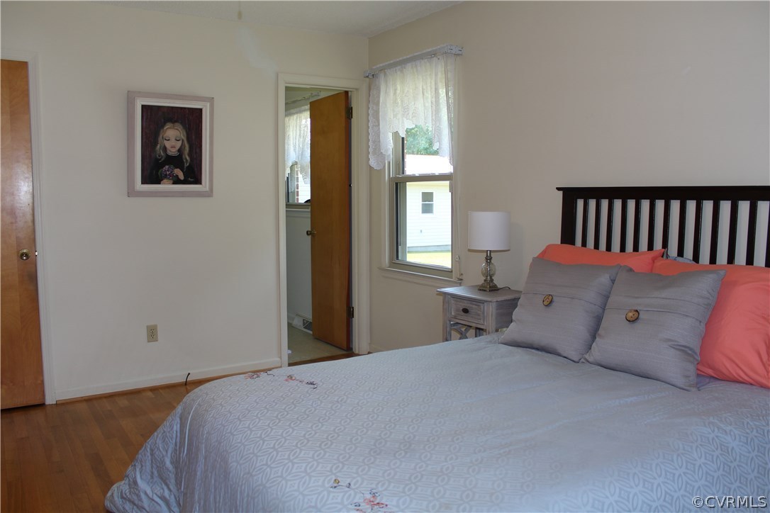 20600 Rowanty Road Carson, VA 23830 - Photo 20 of 25 a bed sitting in a bedroom next to a window and a chandelier