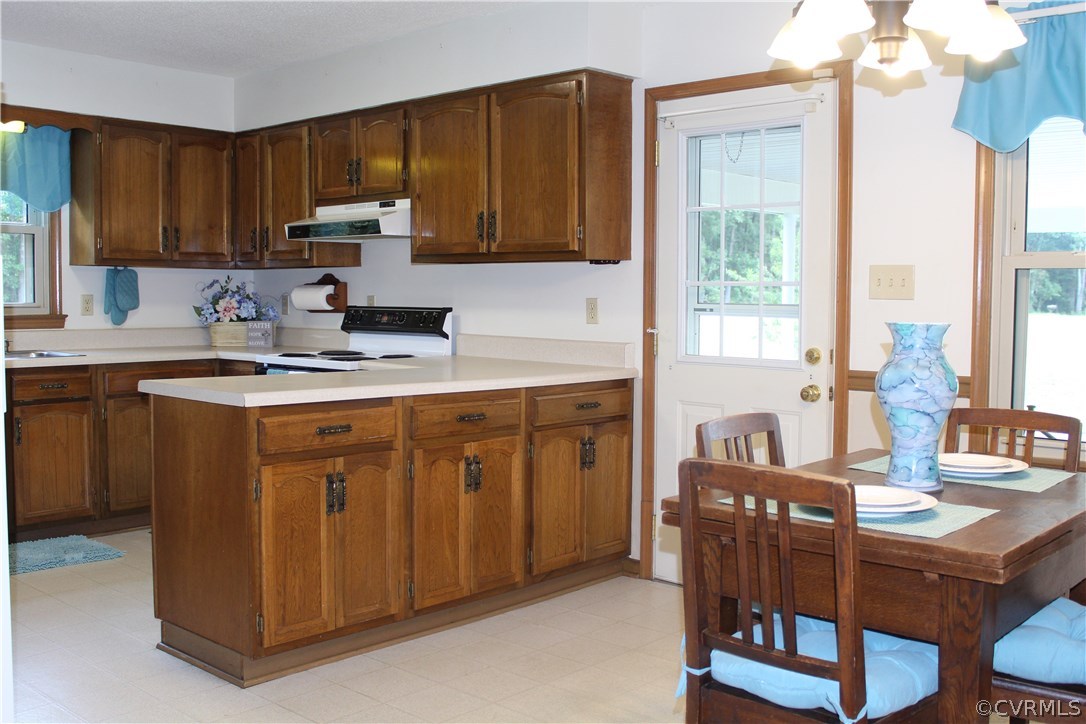 20600 Rowanty Road Carson, VA 23830 - Photo 9 of 25 a kitchen with a stove a sink a refrigerator and wooden cabinets